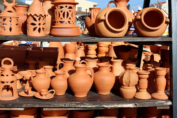 Fototapeta na wymiar Pottery and decorative items made of clay. Clay jugs, candlesticks, lamps. Ceramic market.