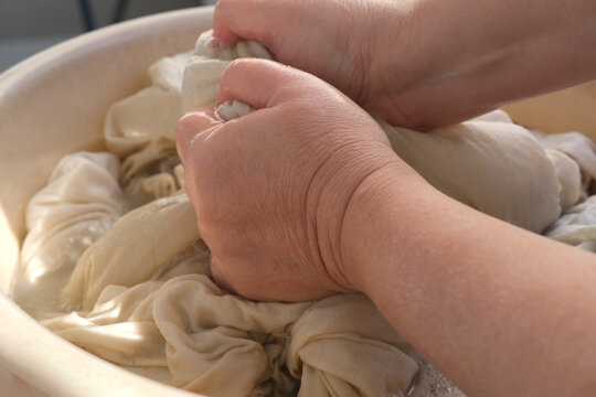 Close-up Female Hands Of Middle-aged Woman Wash At Home In Basin, Pre-soak Dirty Sheets For Washing, Home Chores Concept, Routine Housework, Housekeeping, Washing Machine Broke Down, Selective Focus