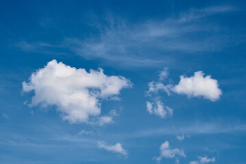 Naklejka na ściany i meble White cumulus clouds in blue sky, beautiful cloudscape background