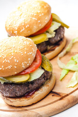 homemade hamburger with pickled cucumber and tomato