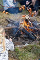 baking sausages at a scout camp