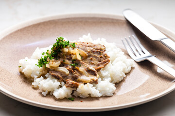 pork meat with onion sauce and rice