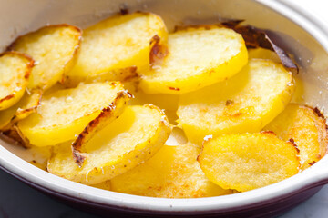 potatoes baked with grated cheese