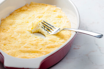 still life of cheese raclette in baking plate