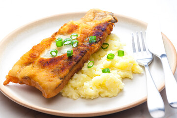 fried fish with mashed potatoes and spring onion