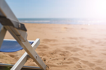 Close up sunbed on the beach at sunset. The beach season is ready for opening. Travel concept