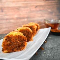 Indonesian snack, Roti gulung abon ikan tuna or Shredded tuna roll on a white folding plate.