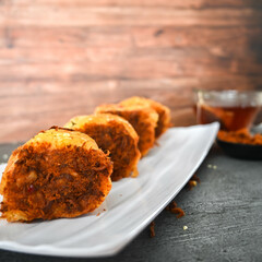 Indonesian snack, Roti gulung abon ikan tuna or Shredded tuna roll on a white folding plate.