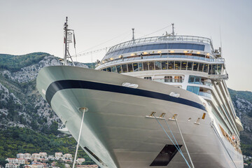 Cruise ship at harbor. Beautiful large white ship at sunset. Colorful landscape with boats in...