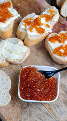 red salmon or trout caviar with white baguette and butter