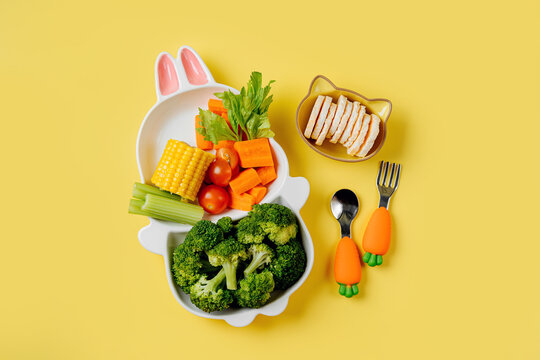 Cute plate in the shape of a bunny with  fresh vegetables. Food idea for kids. Children's healthy food with carrot and broccoli