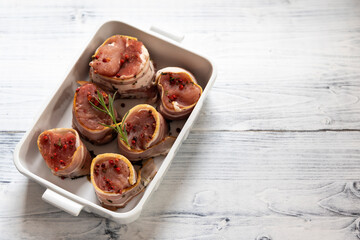 pork tenderloin in bacon on pepper