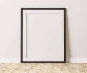 Empty black frame with mat on wooden floor with white wall, 4:5 ratio - 40x50 cm, 16 x 20 inches, poster frame mock up, 3d rendering - obrazy, fototapety, plakaty