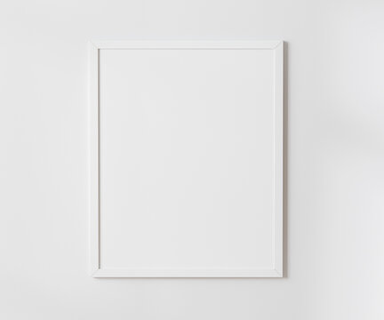White blank frame on white wall mockup, 4:5 ratio - 40x50 cm, 16 x 20 inches, poster frame mockup, 3d rendering