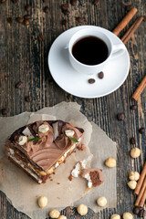 a piece of cake made of chocolate sponge cake cream and caramel with hazelnuts