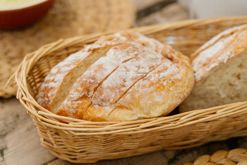 Freshly baked sliced ​​bread in a wicker basket on the table. Table setting. Home baking, healthy food concept.