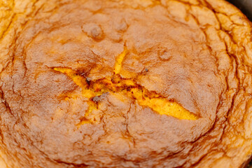 The rich surface of freshly baked bread, the top layer of the cake. Bright and appetizing crust. Texture, close-up view.