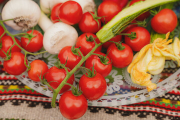 Fresh vegetables on the table. Carrot, garlic, tomato, zucchini flowers, beetroot, kohlrabi, onion, marrow, potatoes, celery, radish, cucumber,  peas. Healthy organic food concept. 