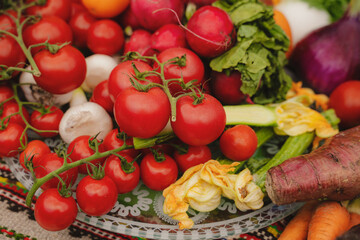 Obraz na płótnie Canvas Fresh vegetables on the table. Carrot, garlic, tomato, zucchini flowers, beetroot, kohlrabi, onion, marrow, potatoes, celery, radish, cucumber, peas. Healthy organic food concept. 