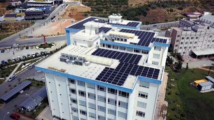 Top view of roof of white building with solar panels. Clip. Modern equipping of buildings with eco-friendly electricity using solar panels on roof