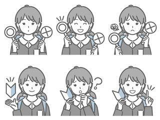 〇✕マークや初心者マークを持つ小学生女子