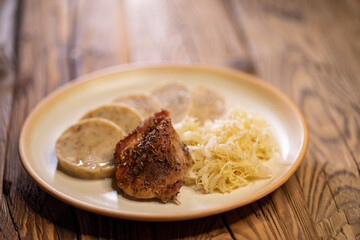 typical Czech cuisine pork with dumplings and cabbage