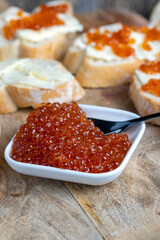 red salmon or trout caviar with white baguette and butter
