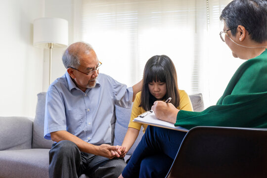 Parents telling the psychologist about family or child problems. Depressed girl and her parent or grandpa having session with psychiatrist in clinic.