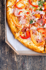 pizza with different ingredients pepper, cheese, sausage and green spices