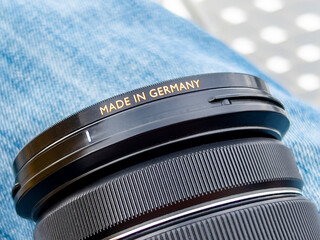 MADE IN GERMANY golden text on black camera lens. German industrial goods with advanced mechanical...