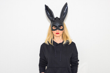 Sexy blond woman in a black bunny mask