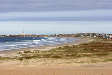 View of Cabo Polonio, a small village in Uruguay, Alternative Community. Important tourist spot, located on the coast, it is possible to see sea, beach, sky, lighthouse, ocean, stones, rocks.