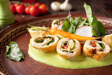 Turkey roll with spinach, broccoli puree and radish salad, restaurant dish, close-up