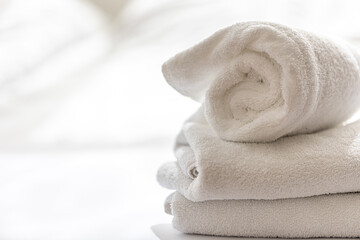 Close up, white terry bath towels stacked, spa concept. - obrazy, fototapety, plakaty