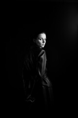 Fototapeta premium woman with closed eyes in leather coat and, black background