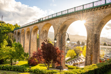 Fototapeta na wymiar Old railway bridge and garden in Vouzela, on a summer day, Viseu District, Portugal