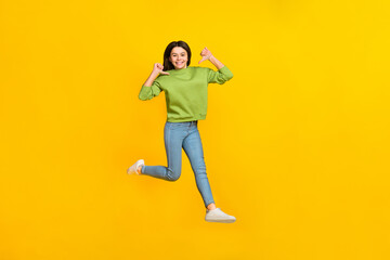 Fototapeta na wymiar Full size photo of young excited girl jump up indicate fingers herself choice isolated over yellow color background