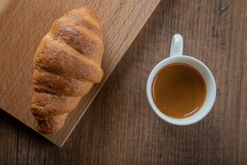 Croissant with espresso in white cup,top view	