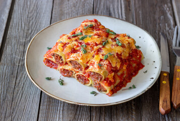 Cannelloni with meat, cheese, tomatoes and thyme. Italian cuisine.