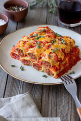 Cannelloni with meat, cheese, tomatoes and thyme. Italian cuisine.