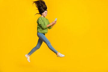 Fototapeta na wymiar Full size profile side photo of young girl energetic use button chat type mobile blogger isolated over yellow color background