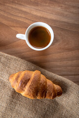Croissant with espresso in white cup,top view	