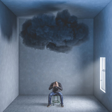 desperate man in a room with big black cloud