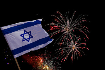 National Israel flag blowing and festive fireworks on black. Independence Day. Concept of...