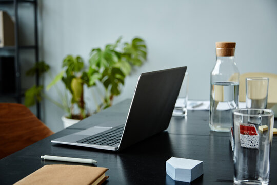 Background image of meeting table with laptop computer and water bottle, copy space