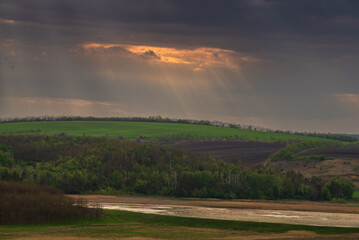 Green meadow, trees and rolling hills at sunset. forest, lake, sun rays, Moldova, Surchiceni