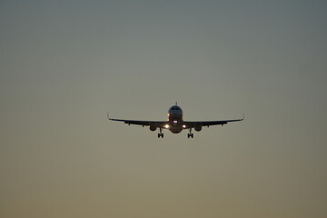Commercial jet flying, in silhouette, in the evening, in Fort Lauderdale, Florida, USA