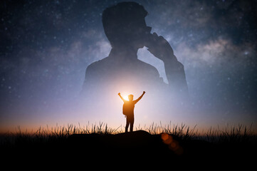 Silhouette of young traveler standing and open arm watched the star and milky way alone on top of...