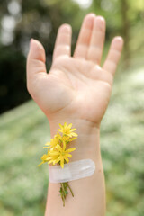 Female hand with flowers at the vaccination site