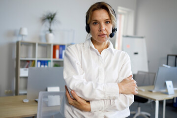 Portrait of serious female call center operator in headset